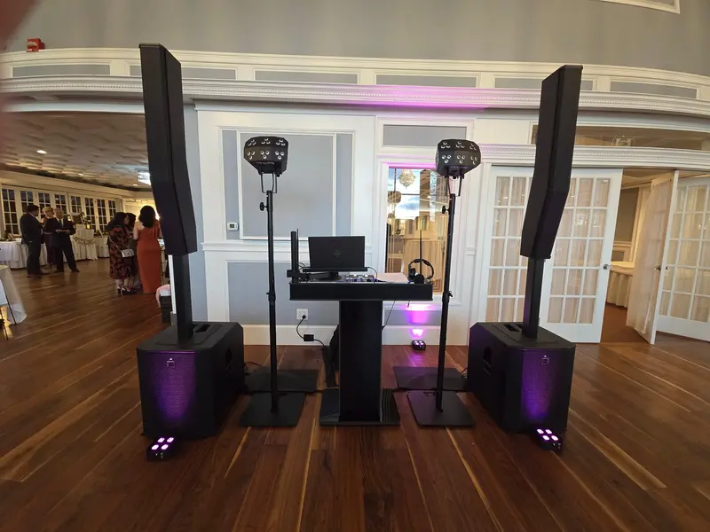 DJ booth with dual column speakers and intelligent lighting in an elegant ballroom
