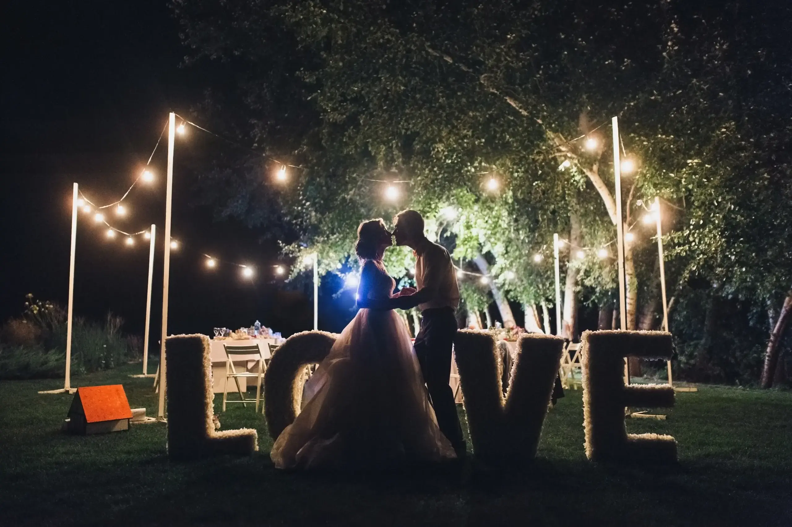 Wedding reception dance floor with professional DJ lighting and uplighting