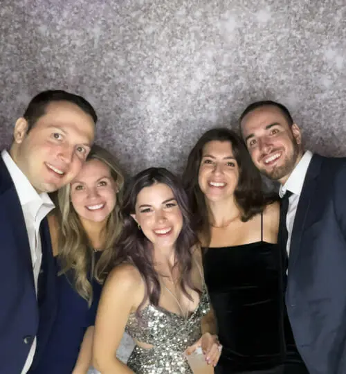 Wedding guests laughing with photo booth props at a New Hampshire venue